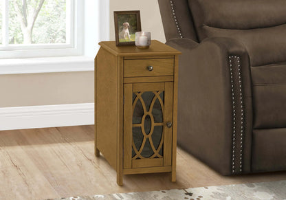 Wooden end table with a drawer and cabinet next to a brown recliner chair.