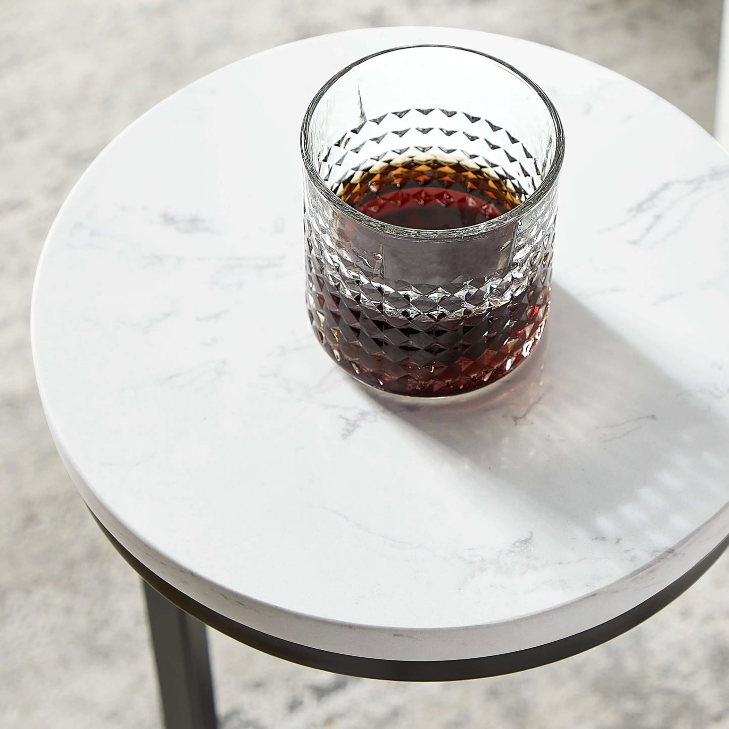 Glass of red wine on a round marble table top