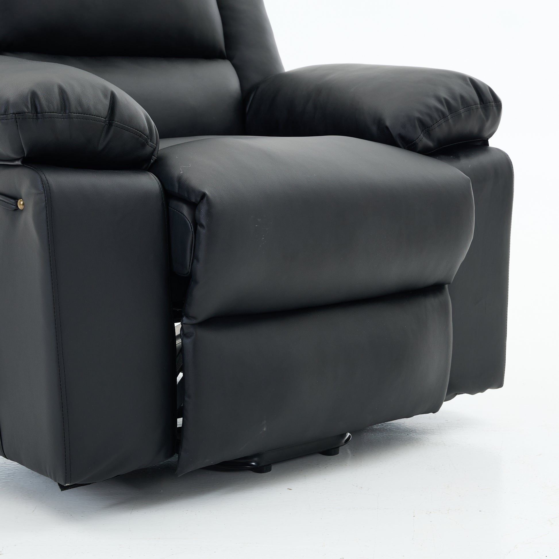 Close up of a black recliner chair footrest and metal base on a white background