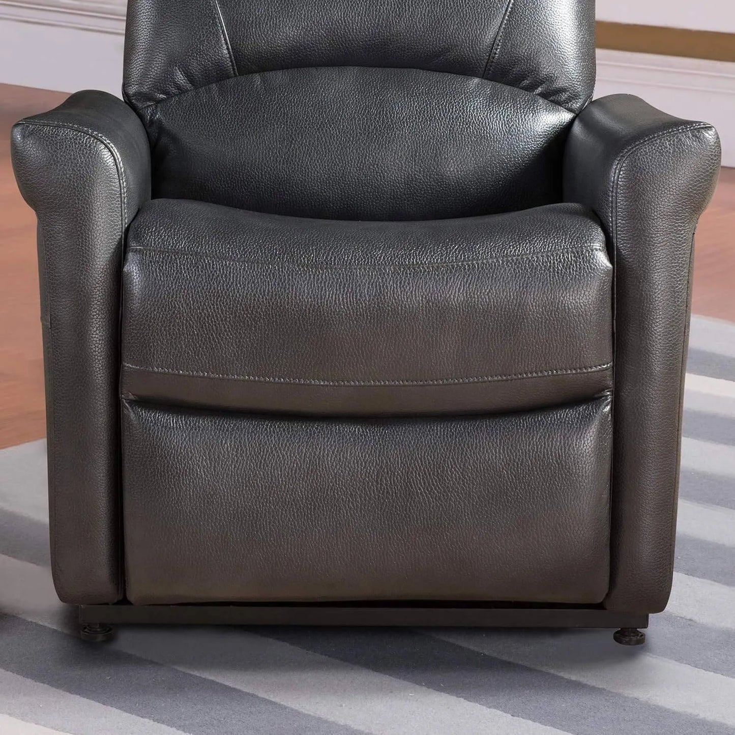 Black faux leather armchair on a striped rug