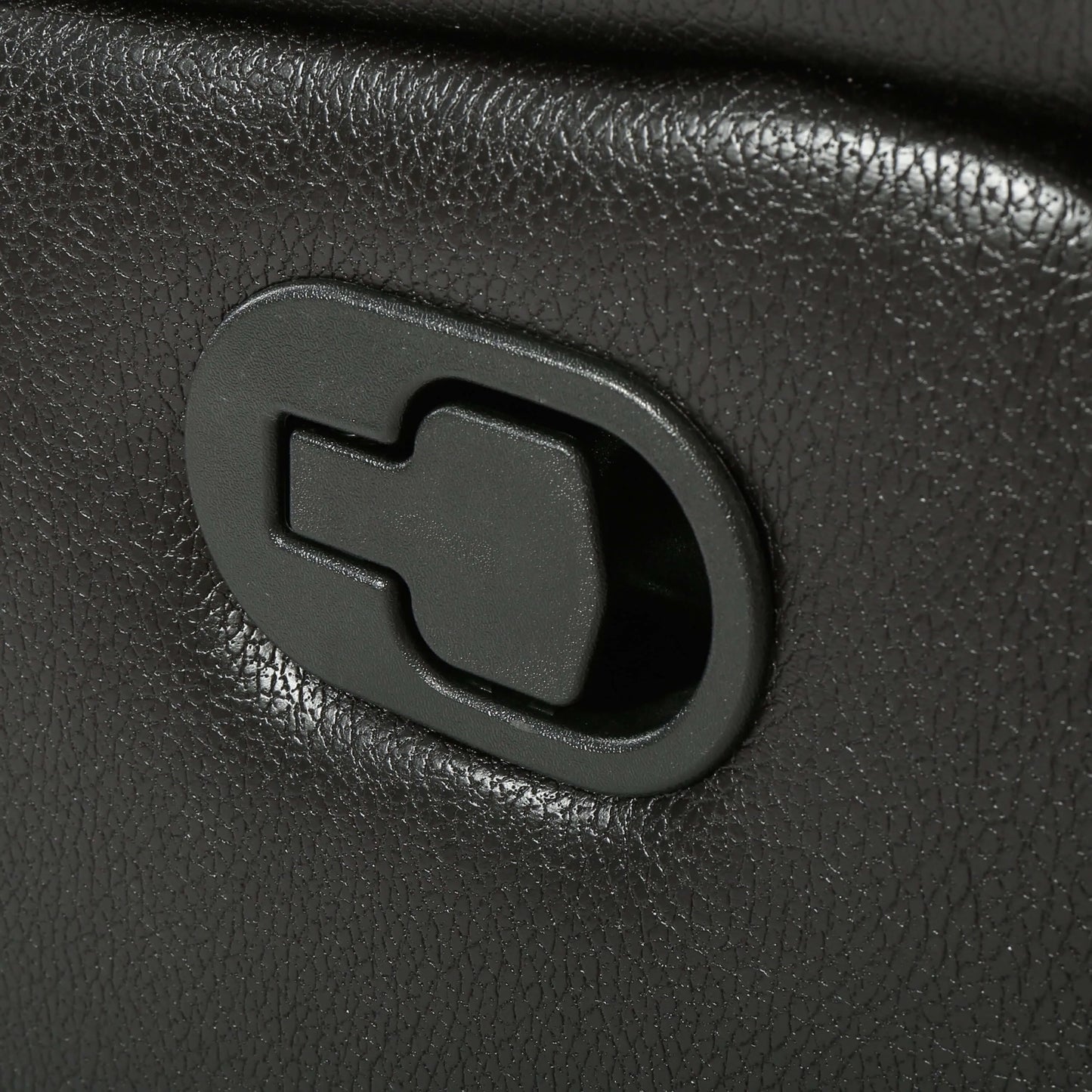 Close-up of a black faux leather glider recliner manual reclining lever