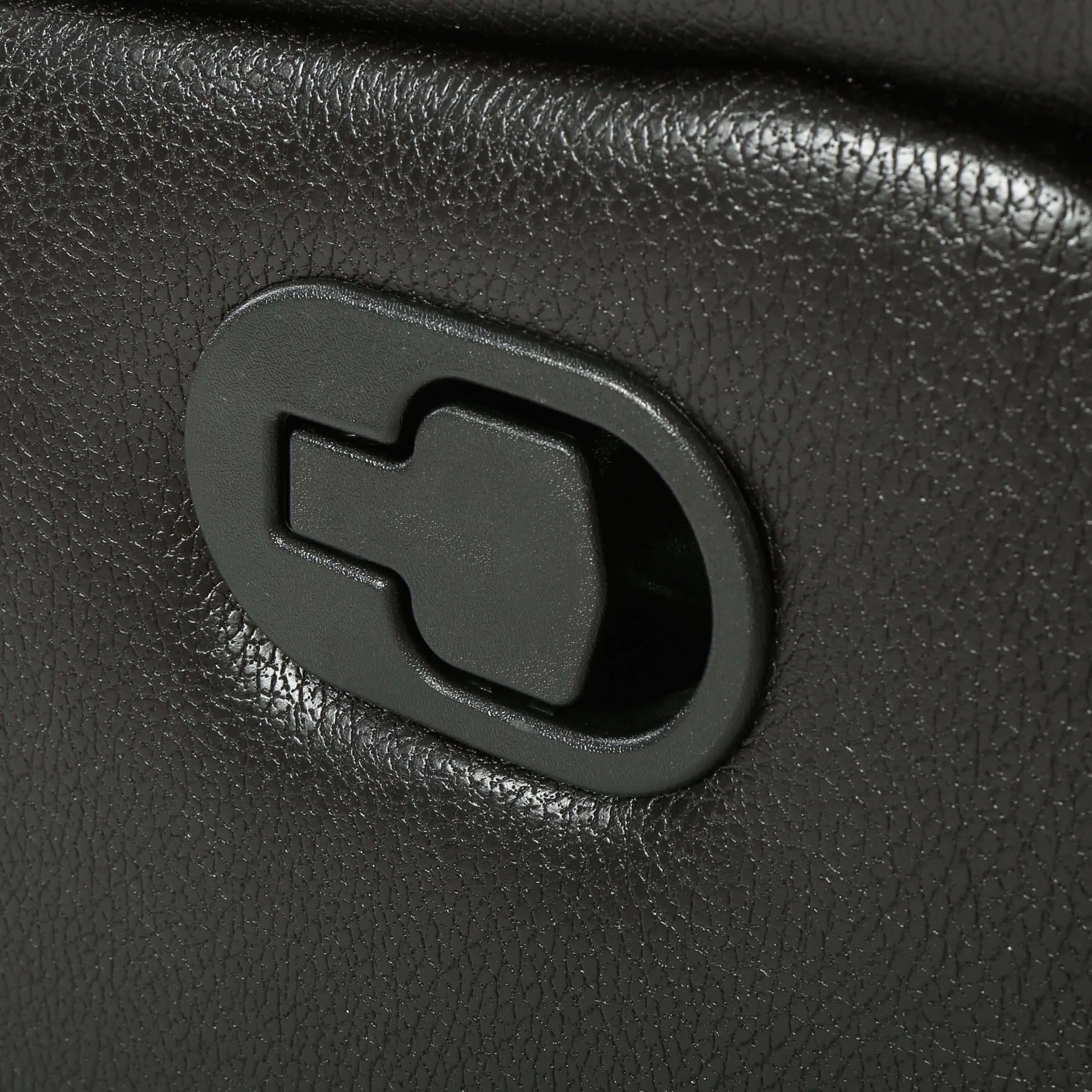 Close-up of a black faux leather glider recliner manual reclining lever