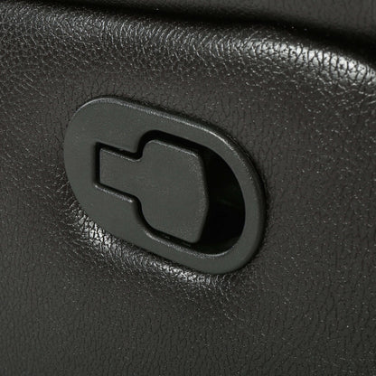 Close-up of a black faux leather glider recliner manual reclining lever