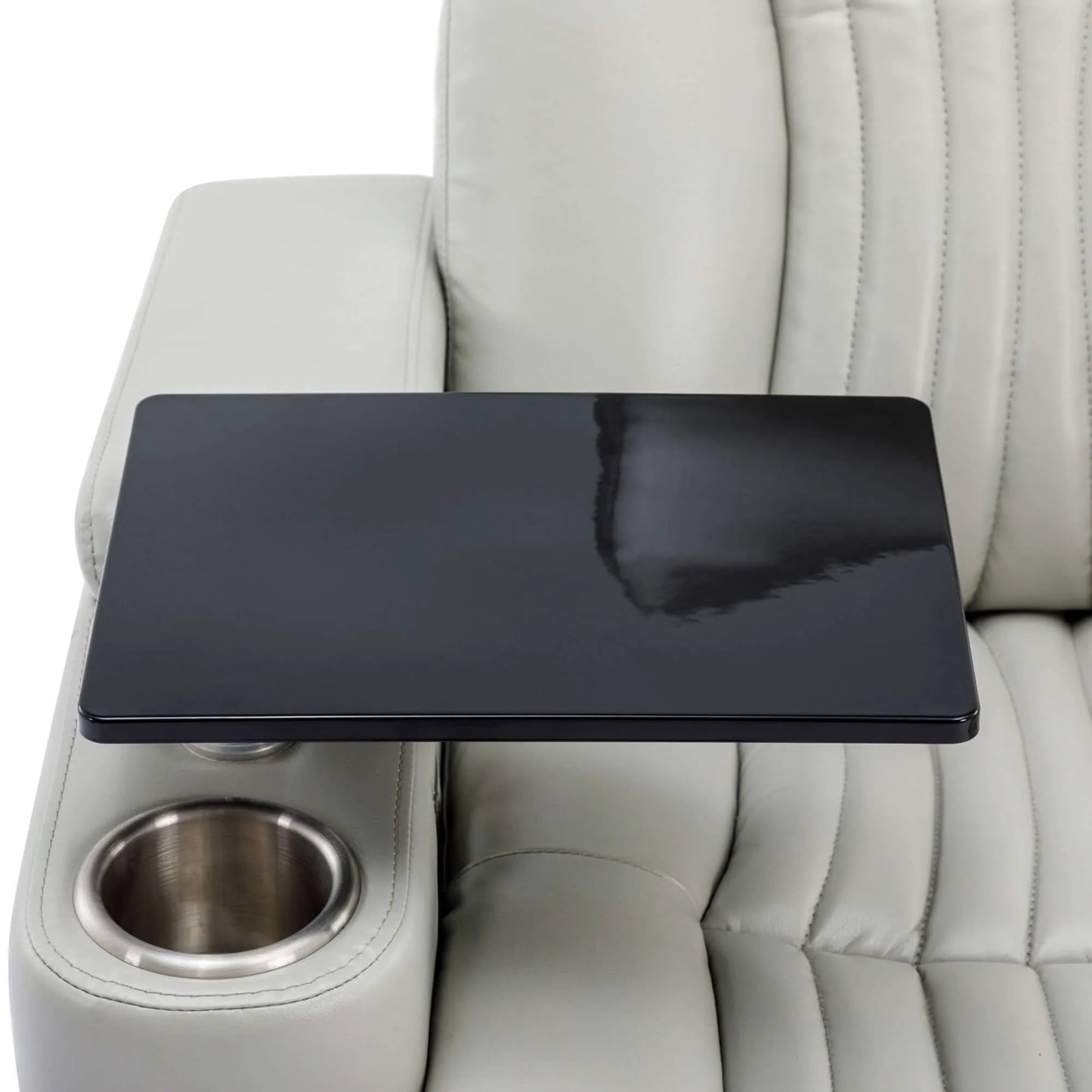 Close up of table attached to a gray leather recliner chair with cup holder on a white background.