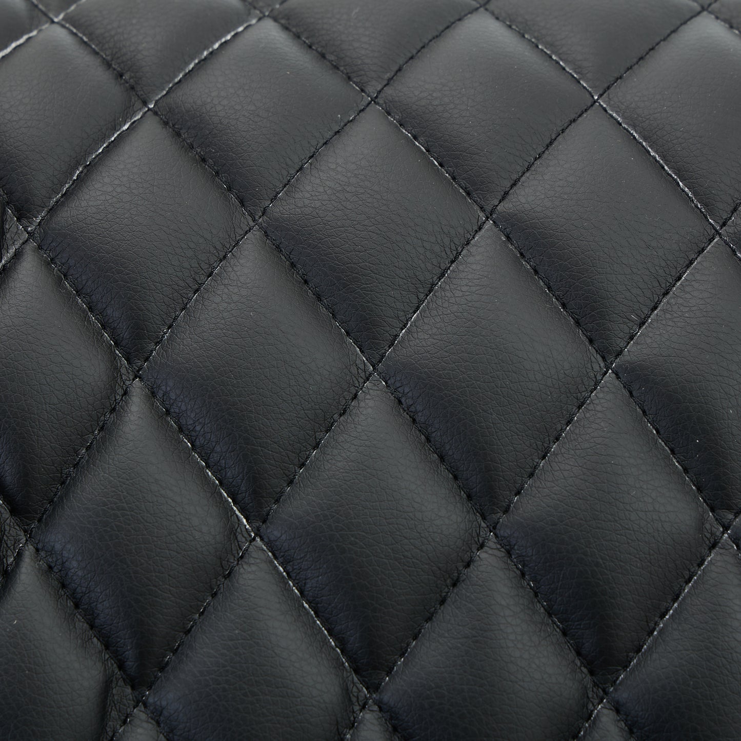 Close-up of black quilted leather texture