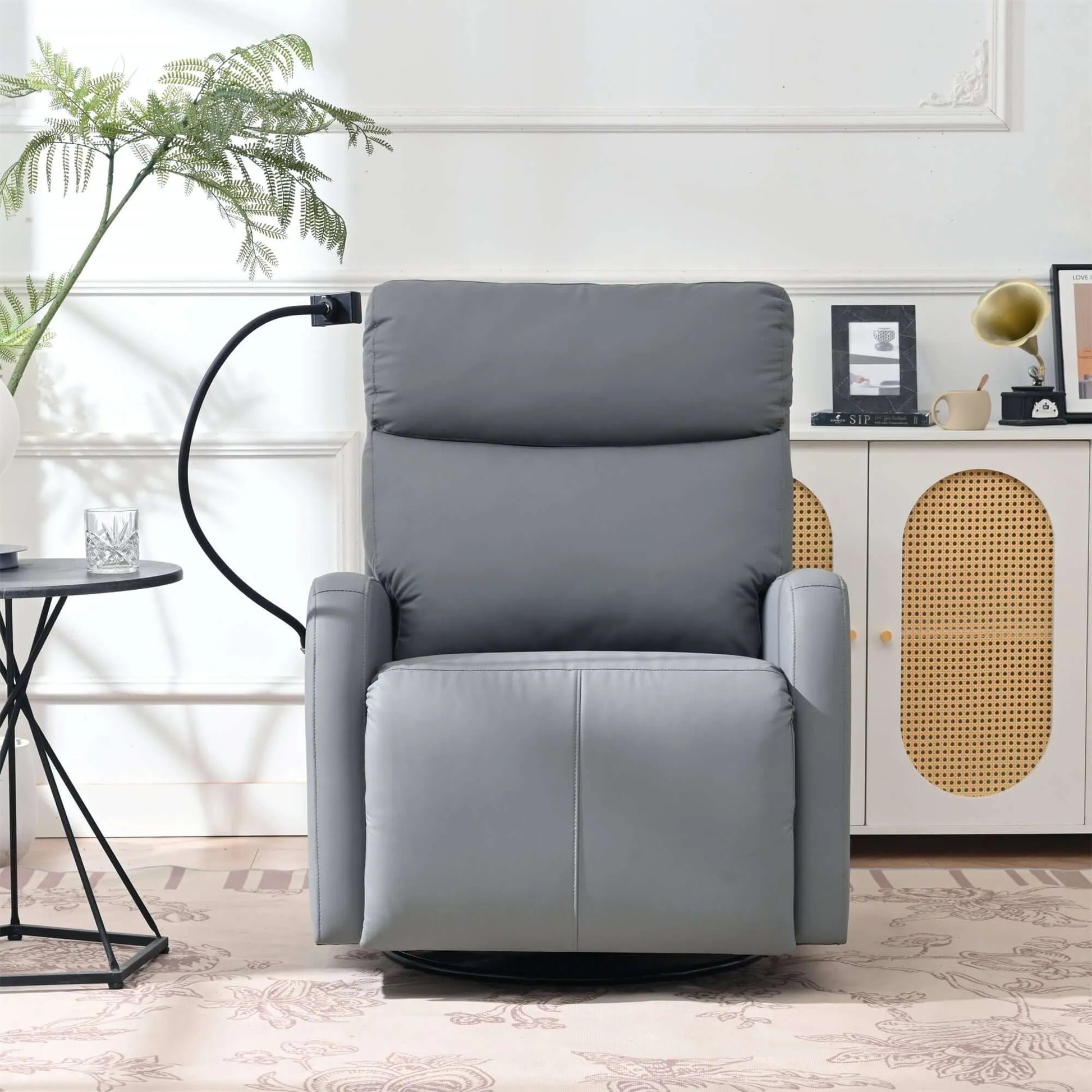 Front view of a gray recliner chair in a room with a plant and side table.