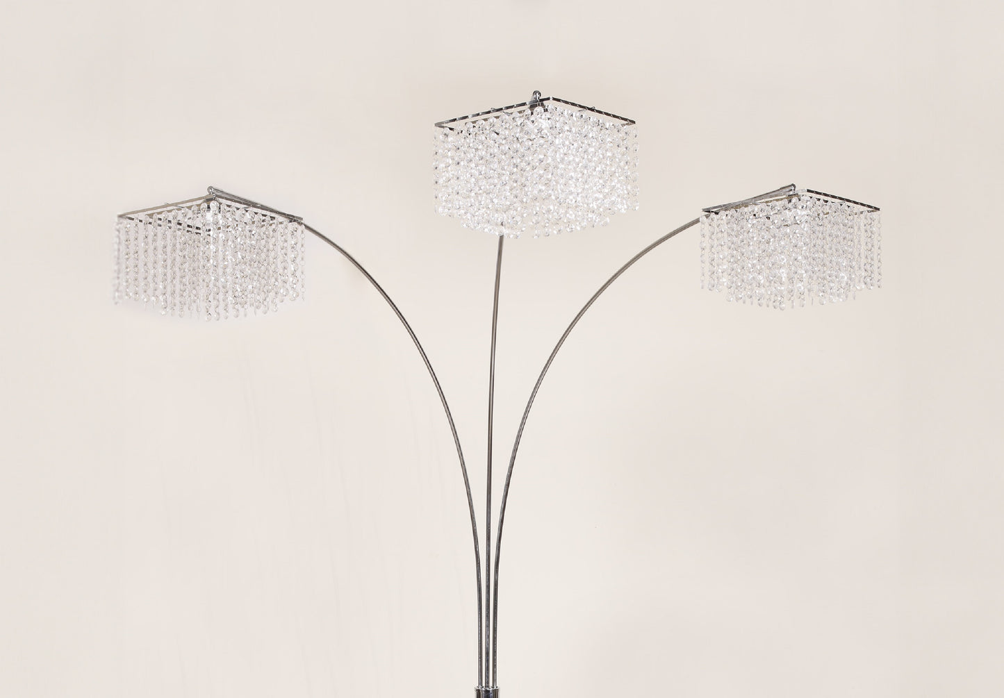 Three-tiered floor lamp with crystal-like shades on a beige background