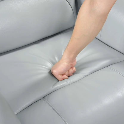Person's fist resting on a light blue leather recliner chair seat cushion