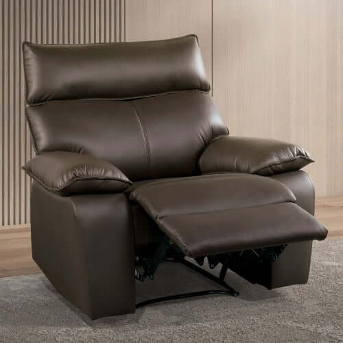 Brown faux leather recliner chair  with footrest extended in a room with wooden flooring and a neutral wall.