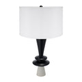 Table lamp with black base and white shade on a white background