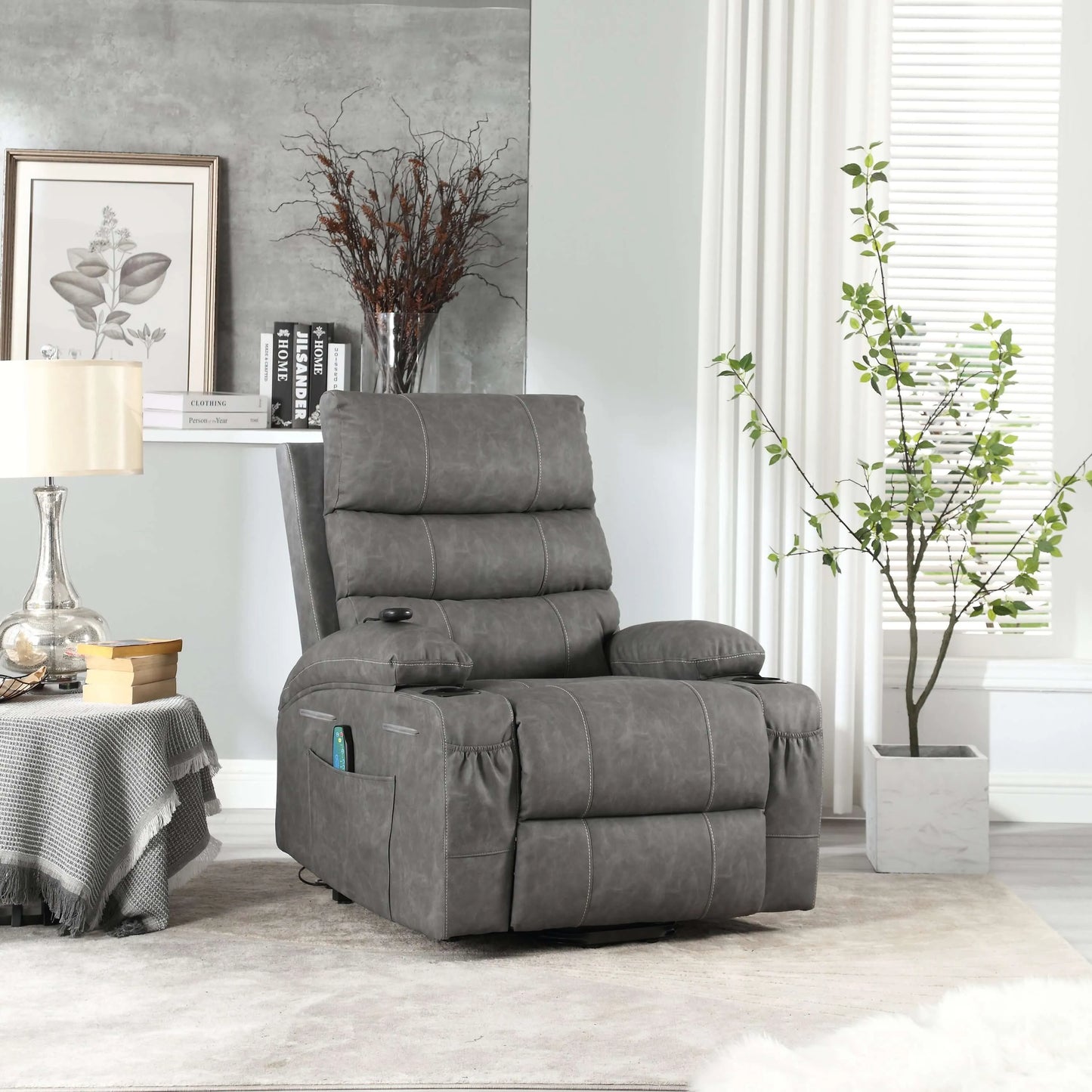 Gray faux leather power lift recliner chair in living room setting with table, lamp and plant