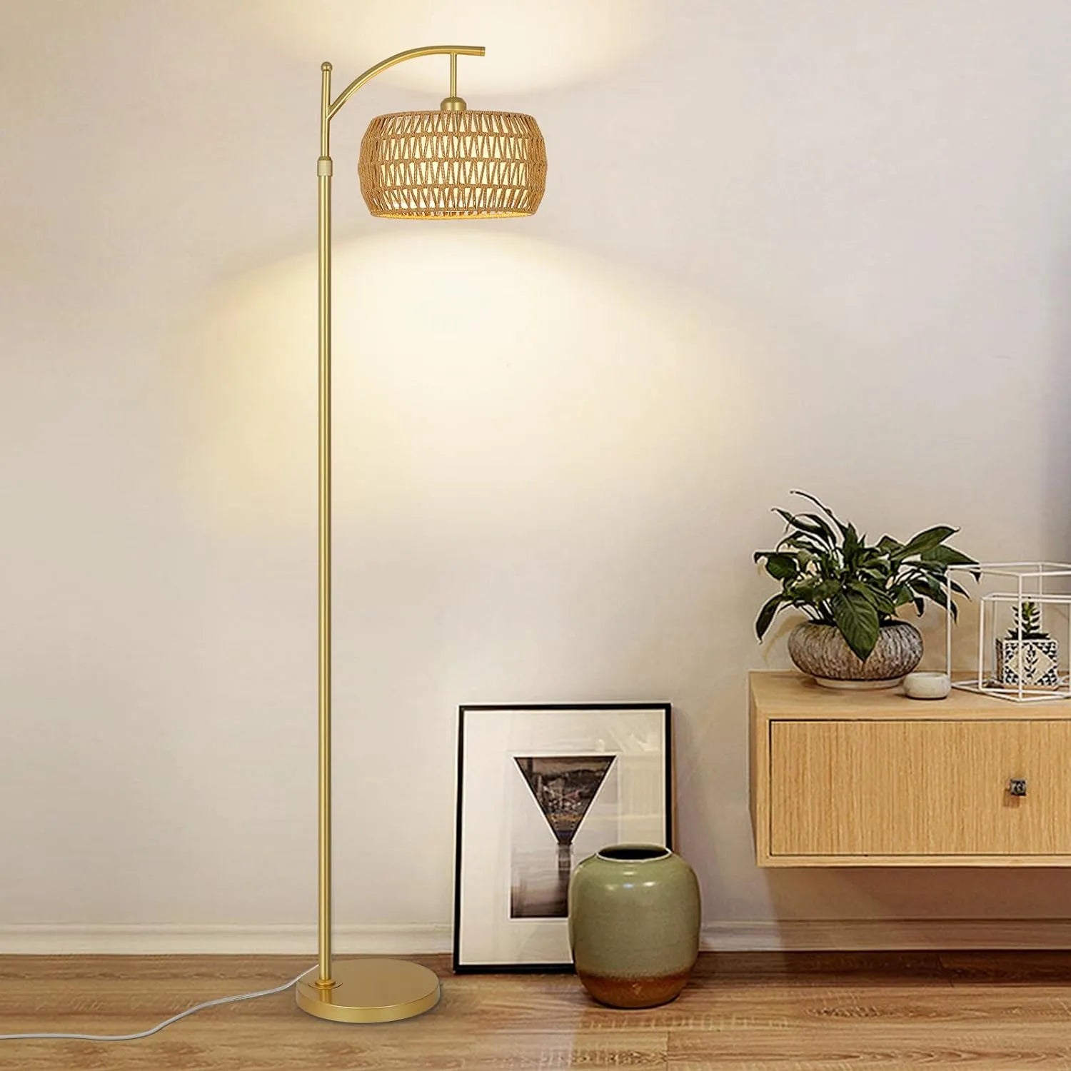 Floor lamp with a woven shade in a room setting with a cabinet and decor items.