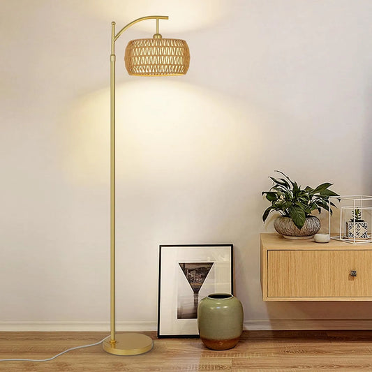 Floor lamp with a woven shade in a room setting with a cabinet and decor items.