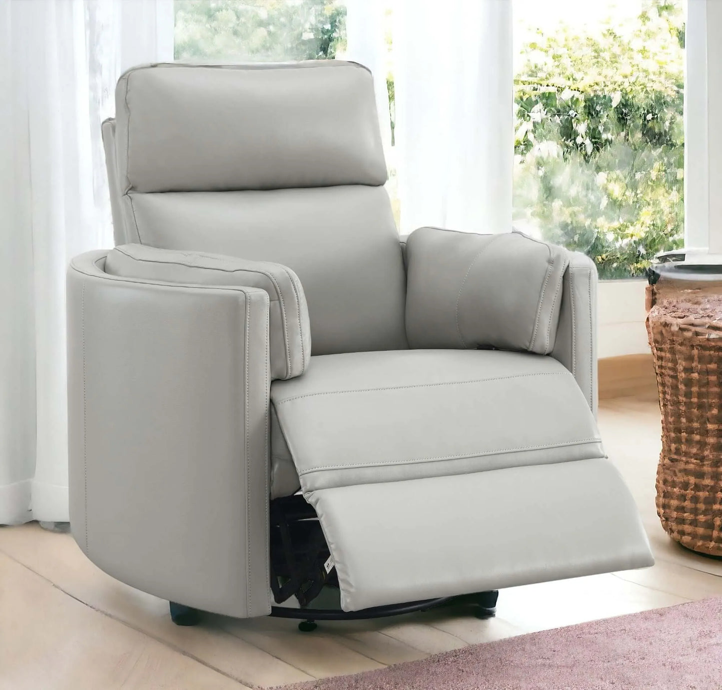 Sagen Gray Faux Leather Glider Recliner chair with Swivel in a living room environment.