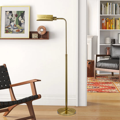 Gold floor lamp in a living room setting with a chair and bookshelf.