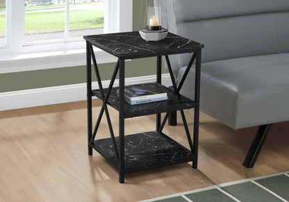 Black marble-patterned end table with two shelves in a living room setting.