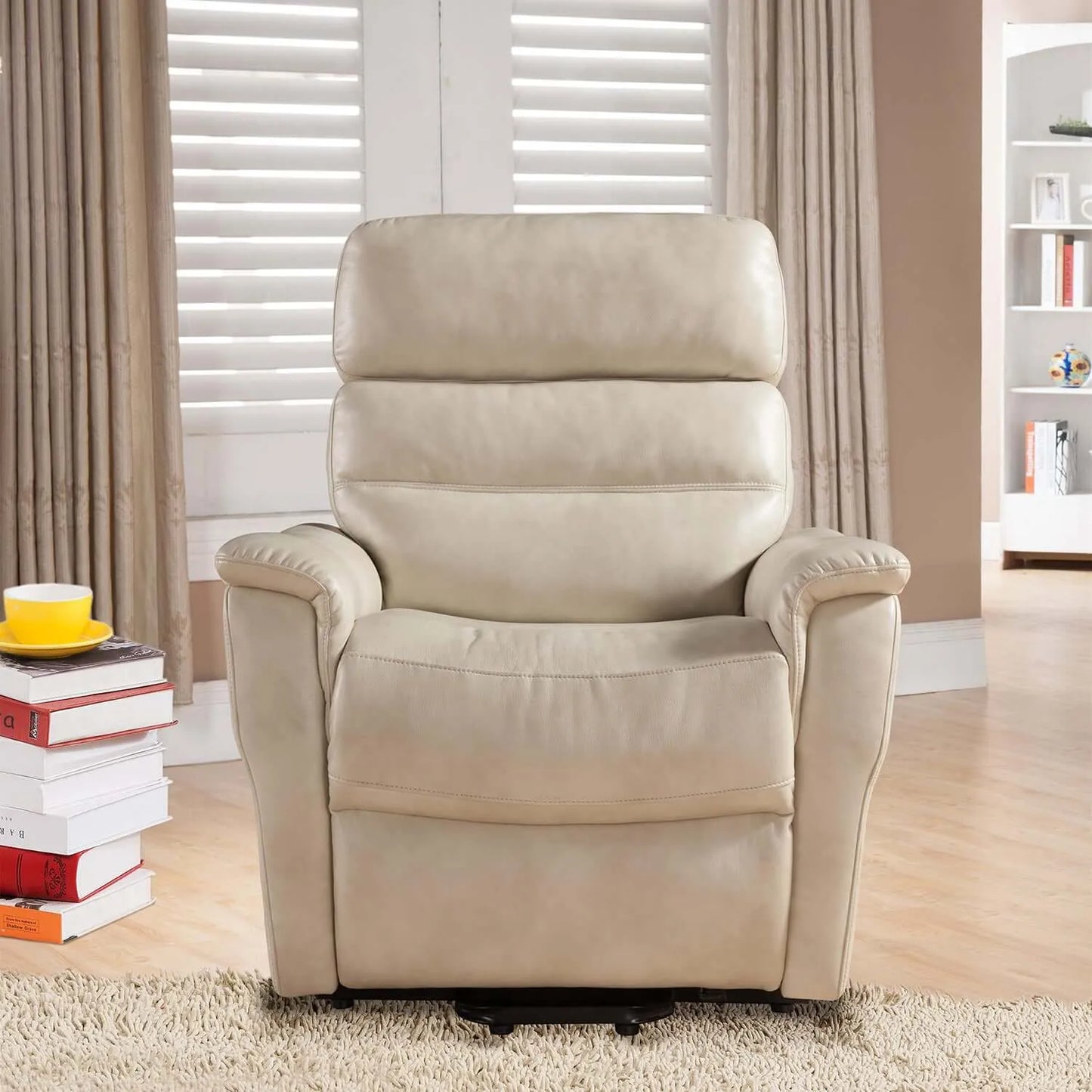 Cream color recliner chair in a living room setting with books and a cup on a small table.
