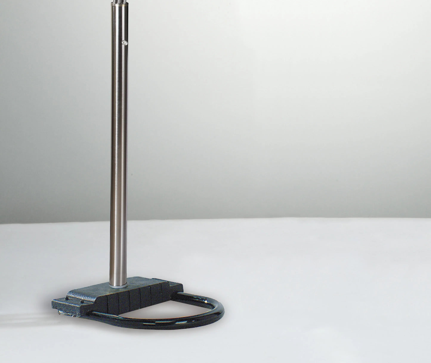 Metal stand with a black base on a white surface