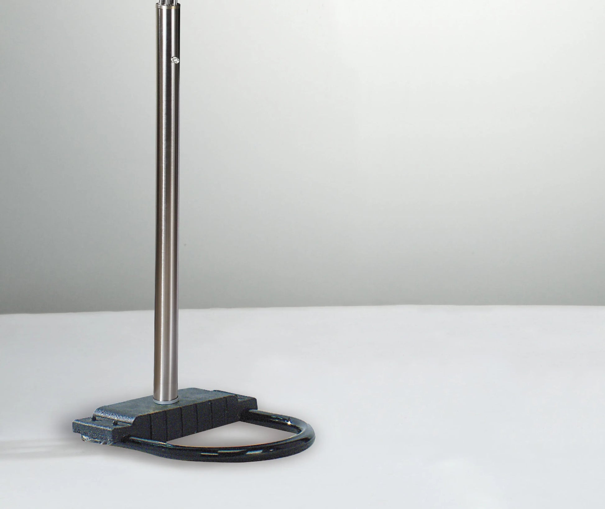 Metal stand with a black base on a white surface