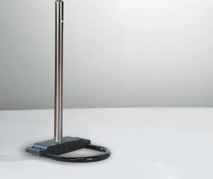 Metal stand with a black base on a white surface