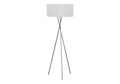 Tripod floor lamp with silver legs and a white shade on a white background