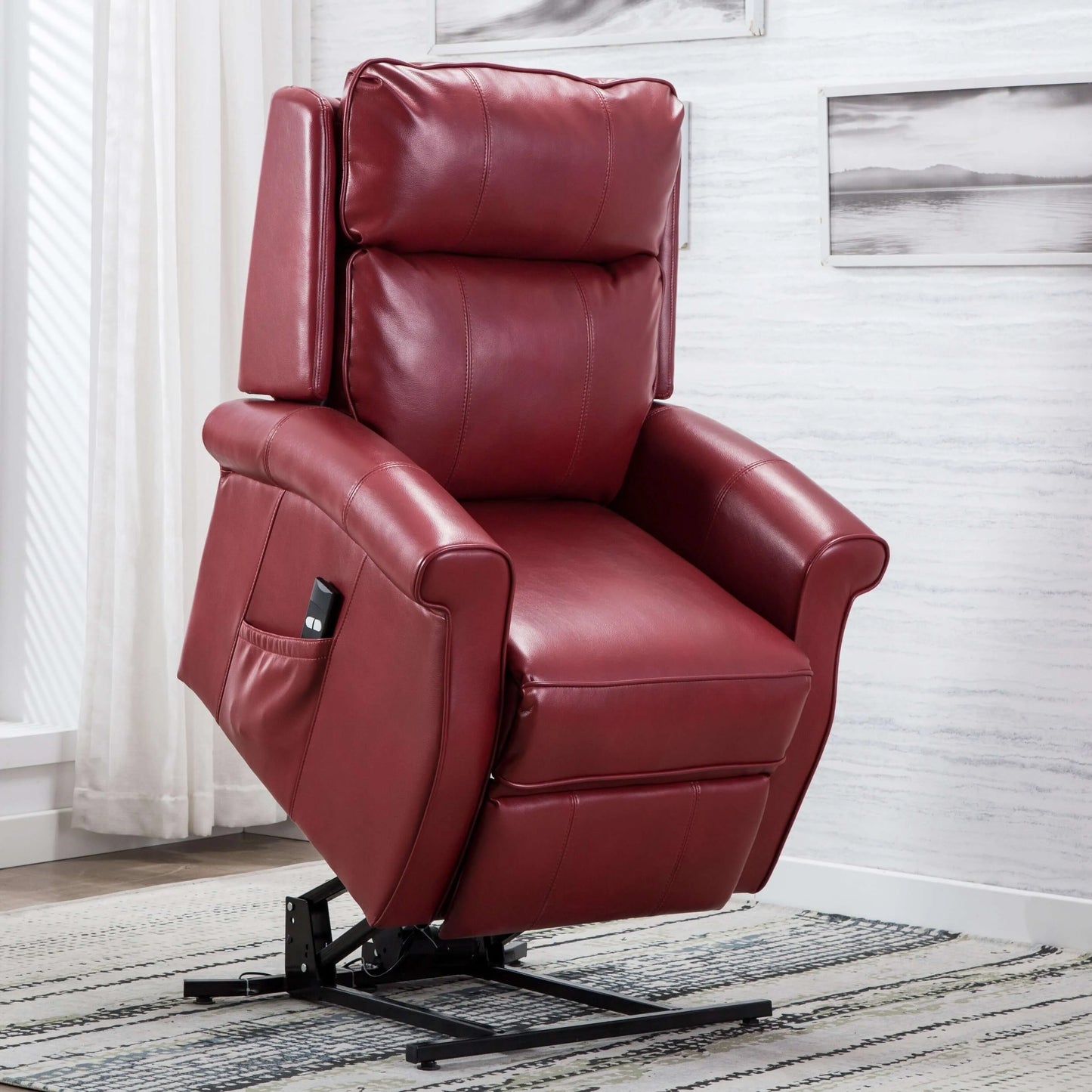 Red leather recliner lift chair in a room with white walls and blurry pictures.