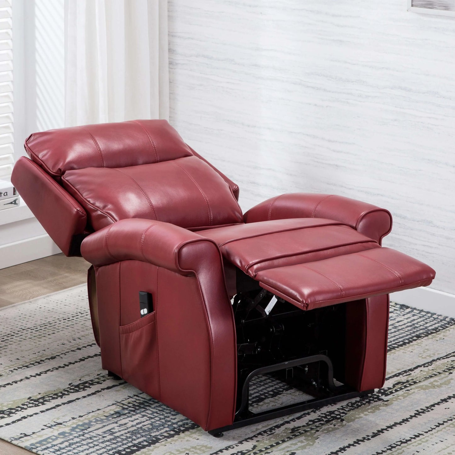 Fully reclined red leather recliner chair in a room with white walls and a rug.
