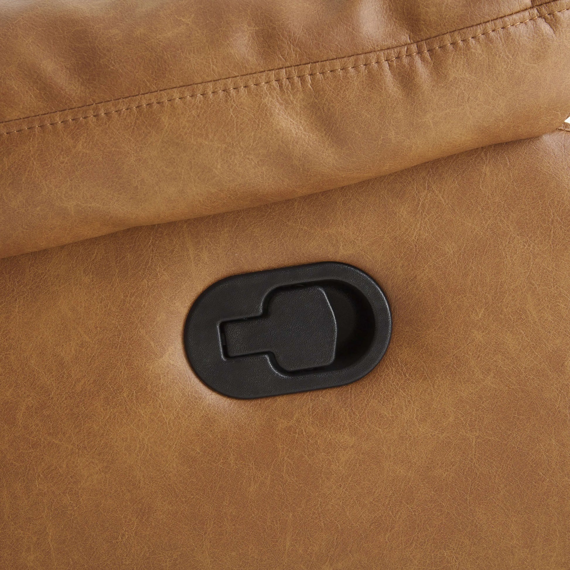 Close-up of a brown leather recliner chair manual pull handle. 