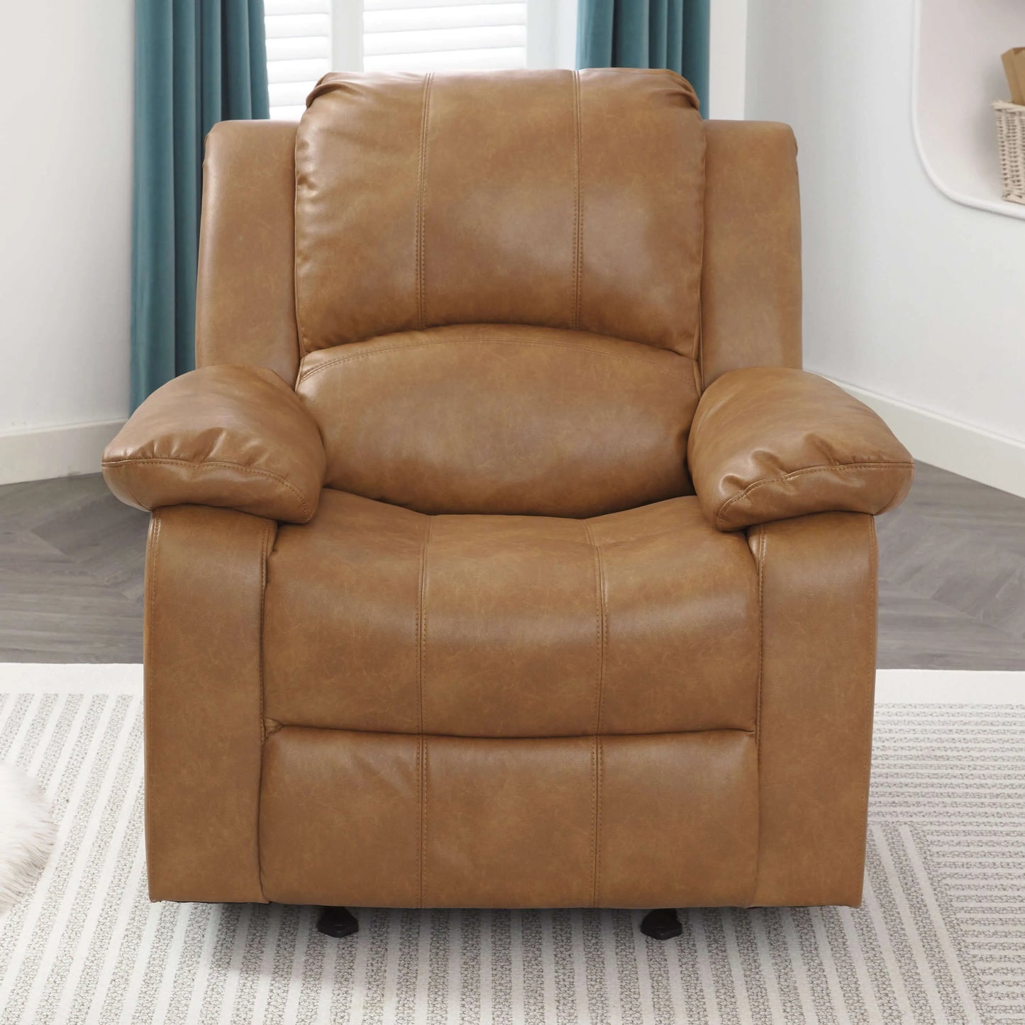 Front view of a brown leather recliner chair in a room with curtains and a rug.