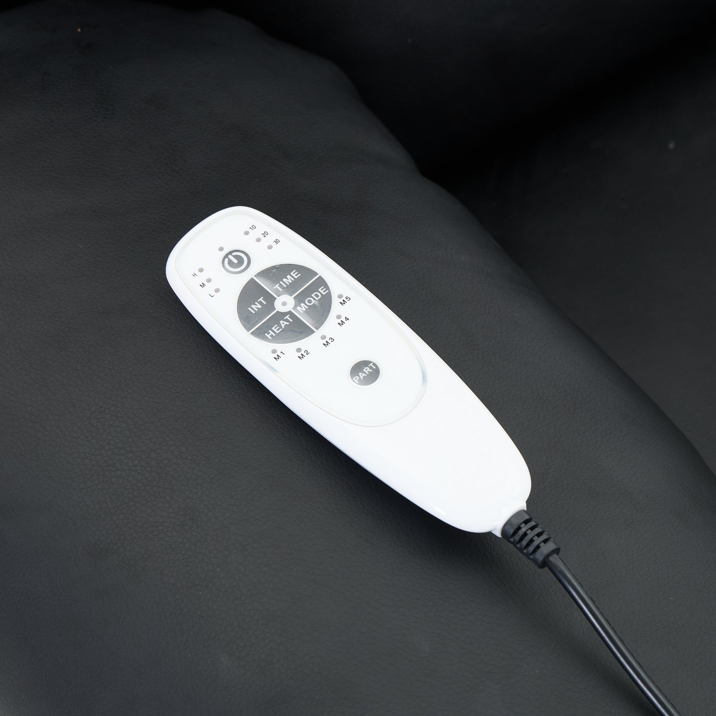 White electronic device with buttons on a dark surface