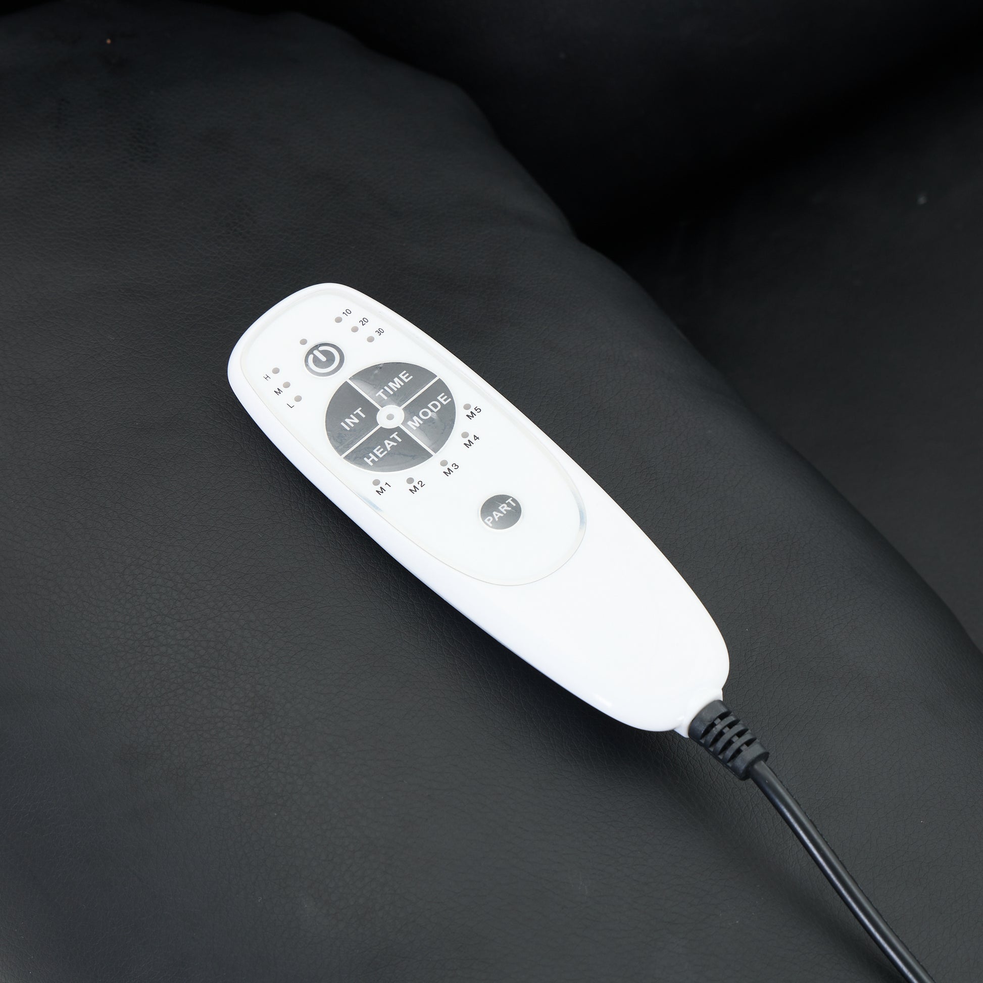 White electronic device with buttons on a dark surface