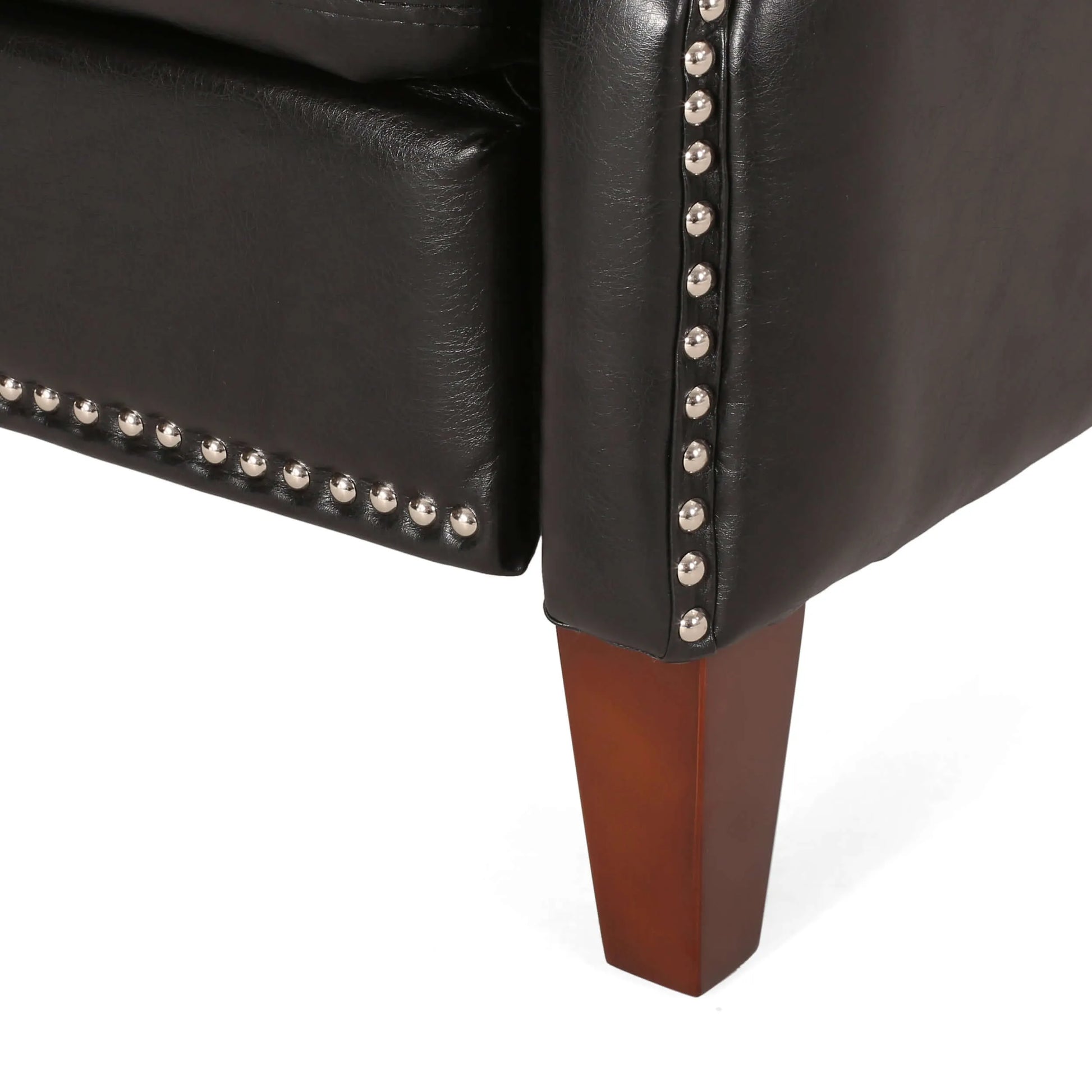 Close-up of a black leather recliner chair with wooden legs and studded detailing on a white background
