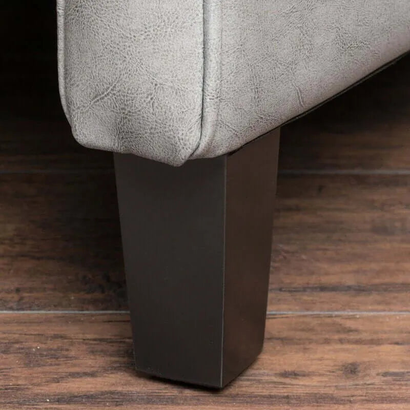 Close-up of chair legs on a gray recliner chair on a wooden floor