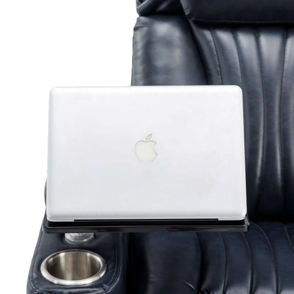 White laptop on a black table with a blue leather recliner chair with a cup holder