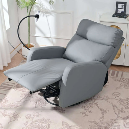 Top view of a fully extended gray recliner chair in a living room setting with a plant and window in the background.