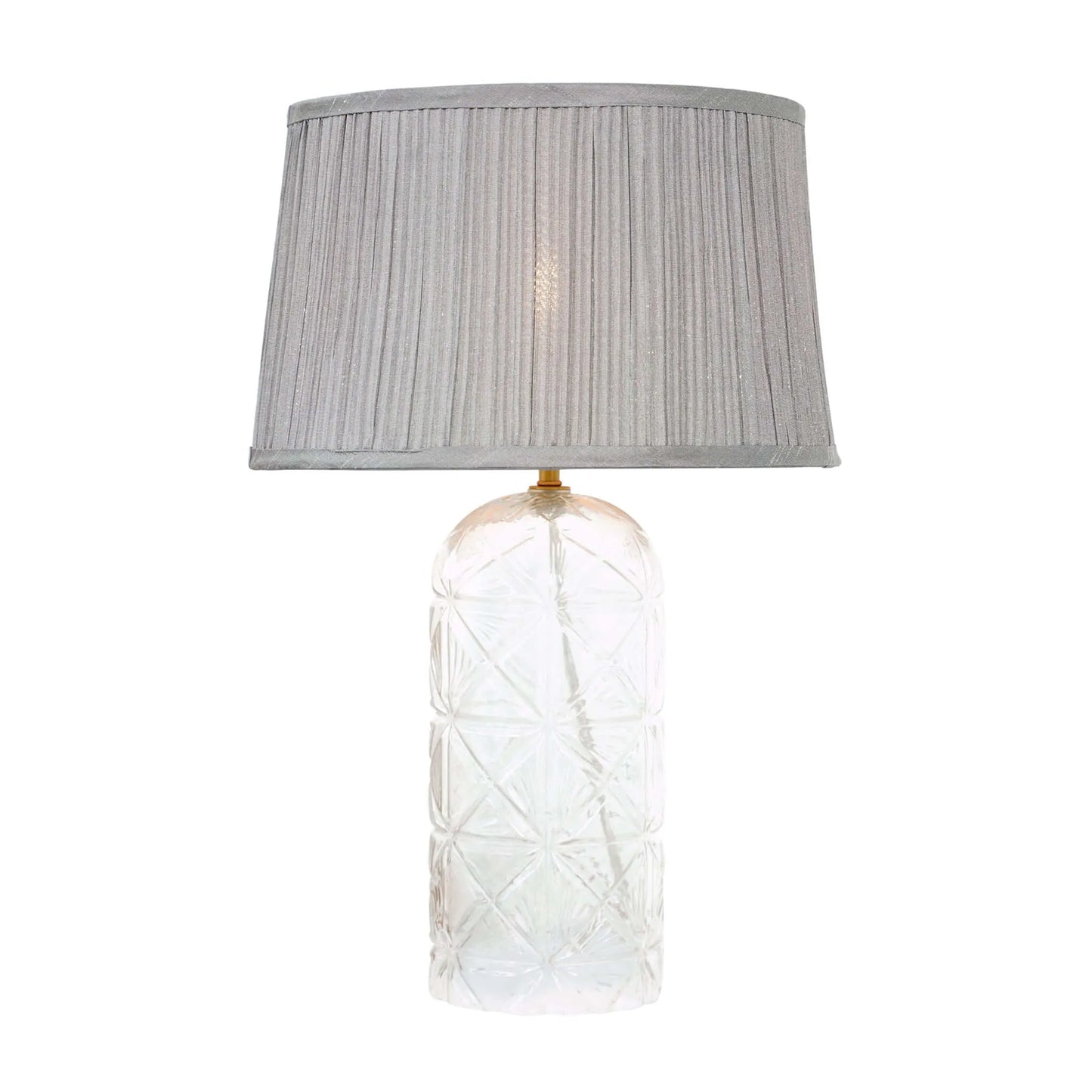 Table lamp with a textured glass base and gray pleated shade on a white background
