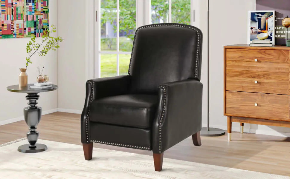 Black leather recliner chair in a living room setting with a wooden cabinet and decor items.