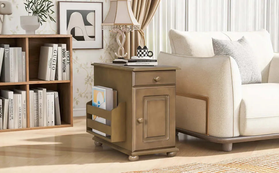 Wooden side table with a drawer next to a beige armchair in a living room setting.
