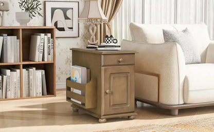 Wooden side table with a drawer next to a beige armchair in a living room setting.