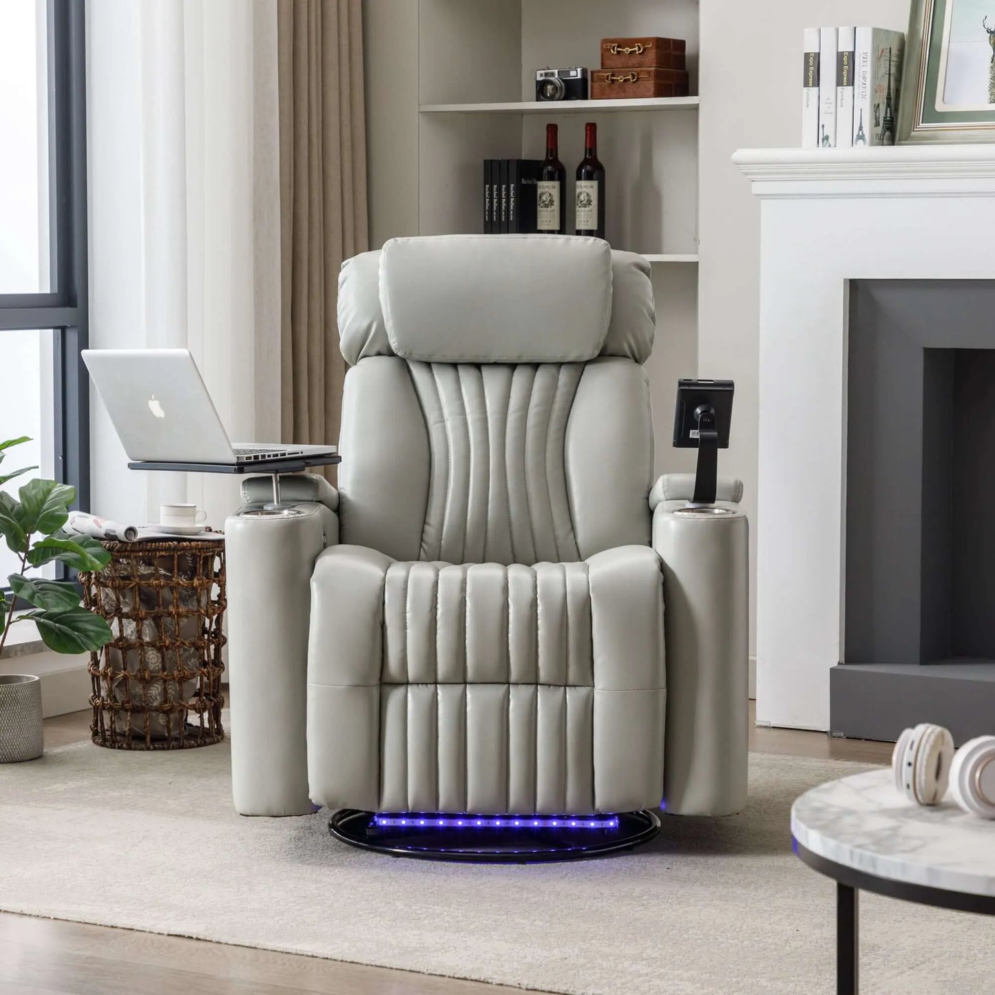 Gray recliner chair in a living room setting with a laptop on a small table.