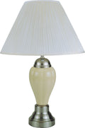 Table lamp with a white pleated shade and cream base on a white background