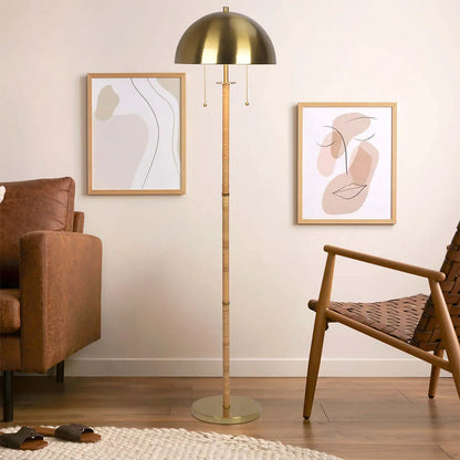 Brass floor lamp with rattan stand in a living room with abstract art on the wall
