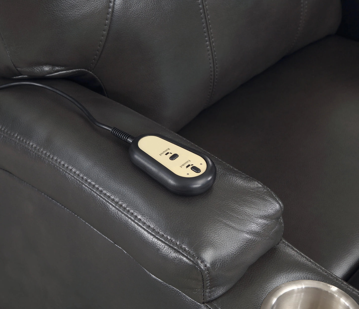 Black massage device on a black leather recliner chair
