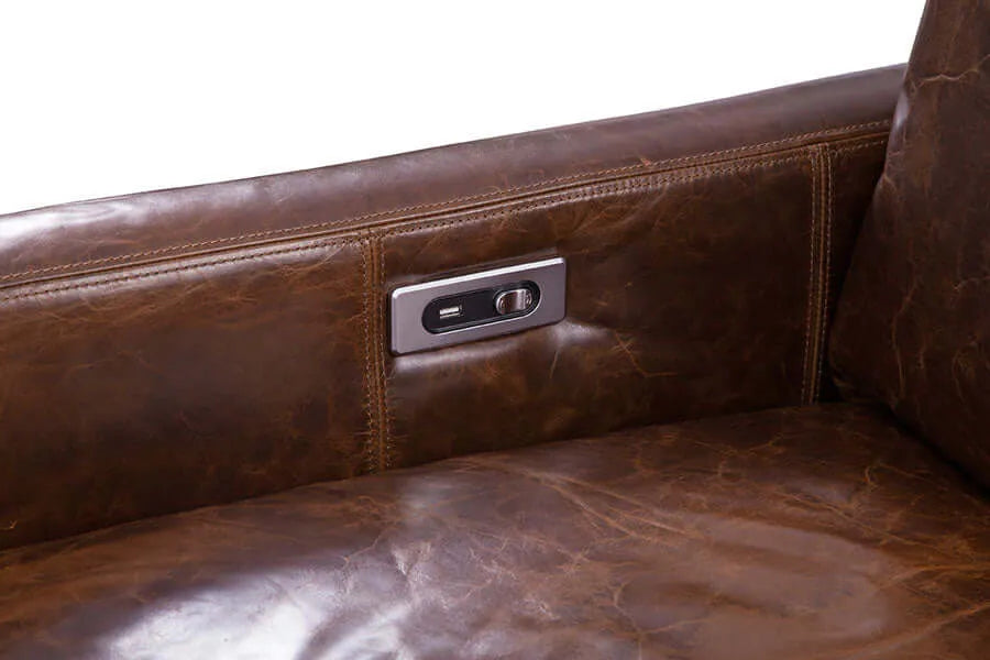 Close up of power controls on a brown genuine leather recliner chair with a metallic handle on a white background