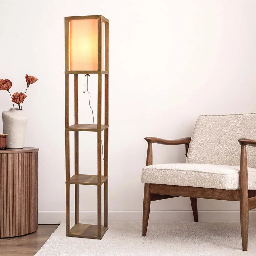 Wooden floor lamp with shelves next to a chair and side table in a room.