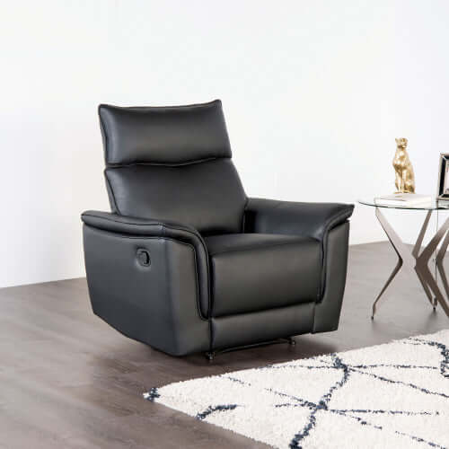 Black leather recliner chair in a modern living room setting.