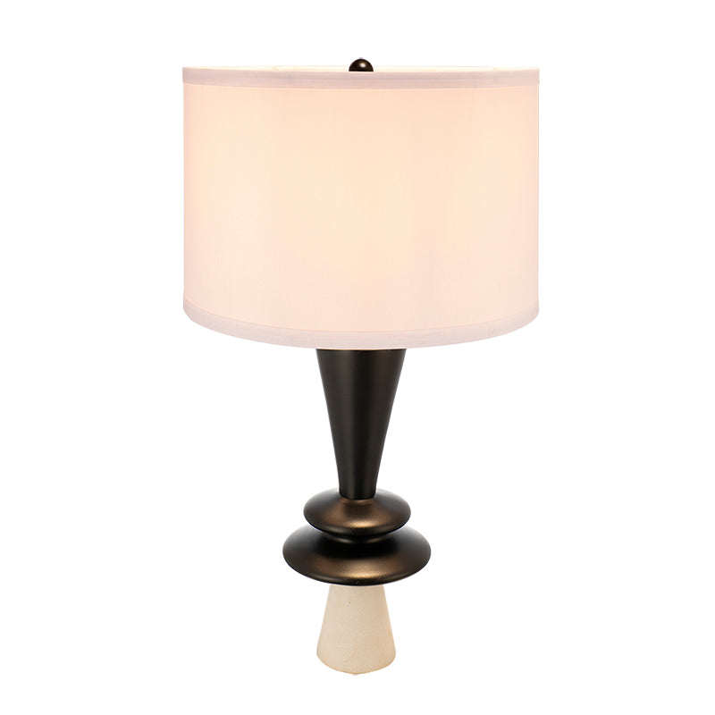Table lamp with a white shade and black base on a white background