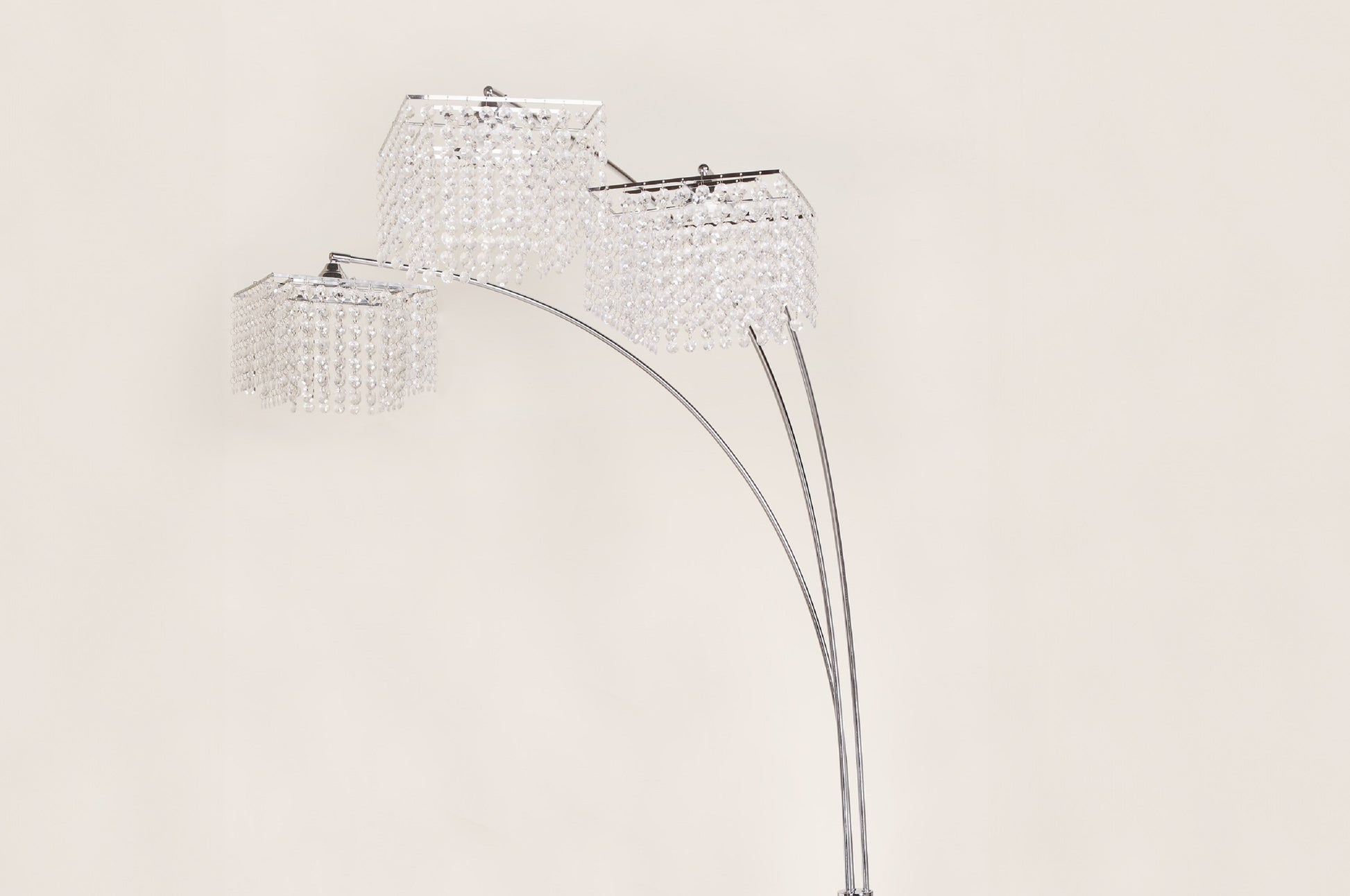 Crystal floor lamp with three lampshades on a beige background