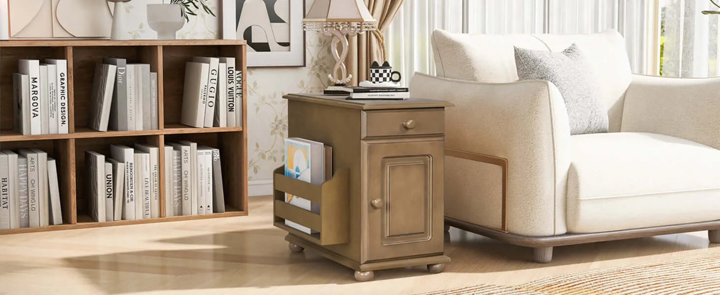 Brown wooden end table next to a white couch and book shelves on carperted floor.