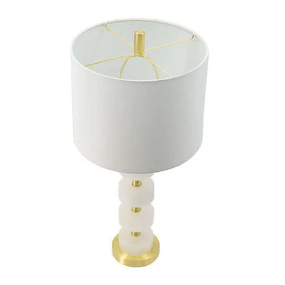 White table lamp with marble accents and gold base on a white background